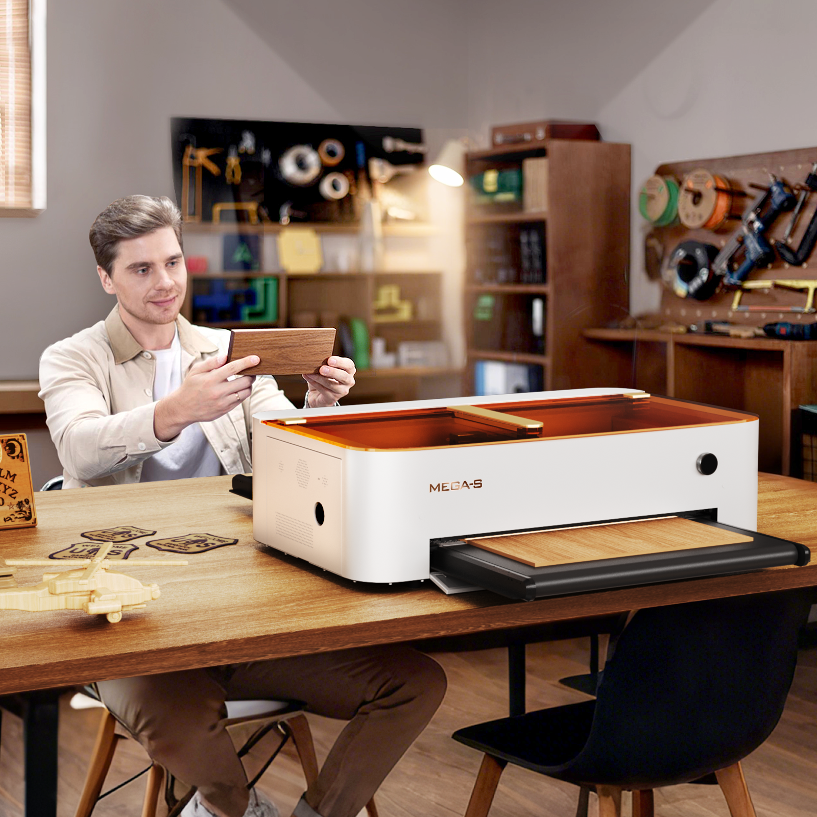 Monport Mega S desktop CO2 laser engraver with a user, suitable for engraving leather wallets
